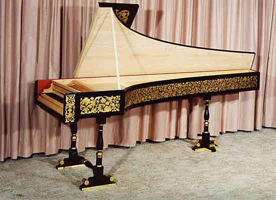 A reproduction of the 1702 Grimaldi harpsichord, with lid open, showing the silverleaf decoration technique on the case side